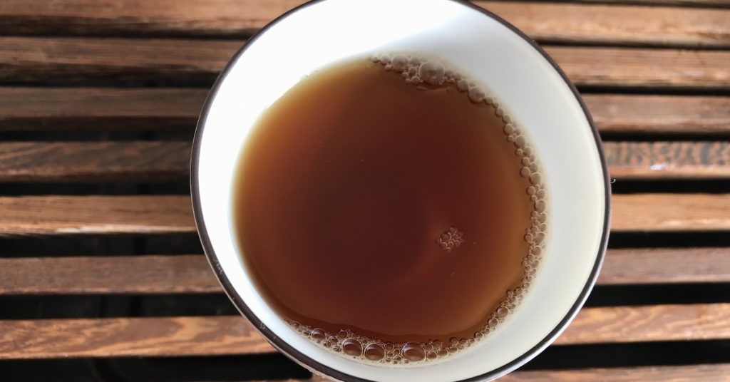 Cold brewed Pu Erh tea in a porcelain tea cup