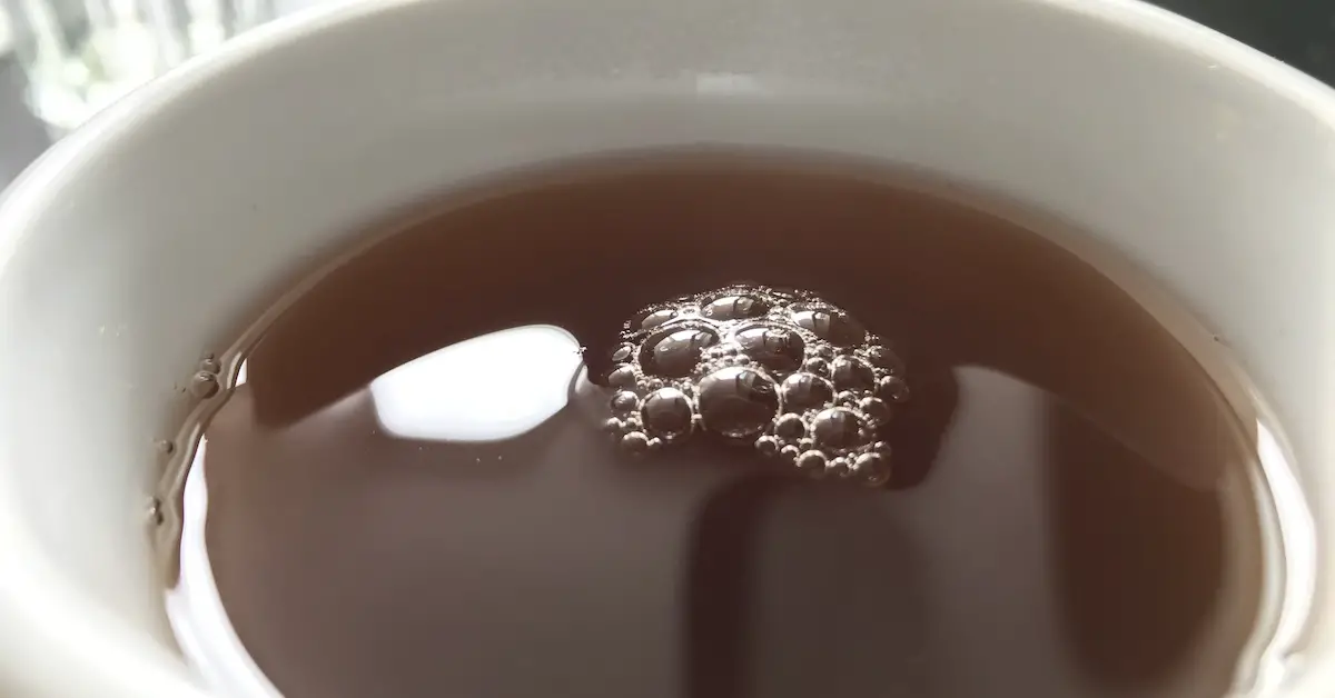 Foam on a cup of black tea